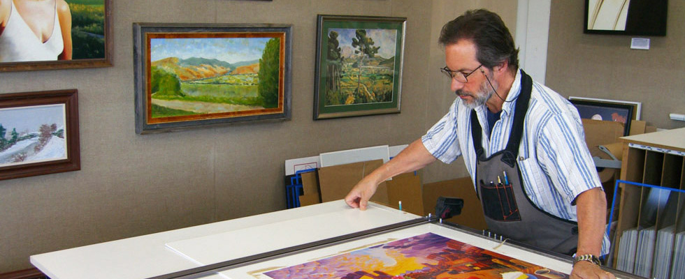 Owner Joseph Guggino framing a picture